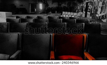 The red chair among chairs. In a lost theatre abandonned