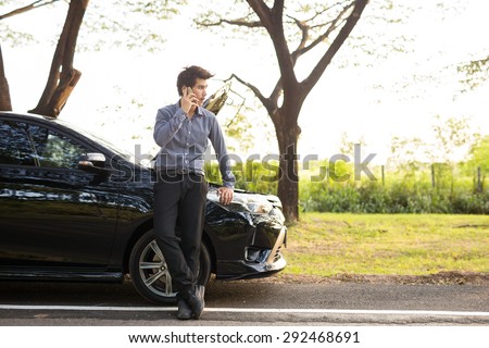 Ofiice guy talking on a cell phone broken car On Country Road Phoning For Help