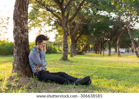 Young business man drowsy after hard work,\
He needs to rest with nature .