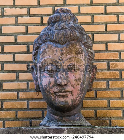 Buddha head on brick wall background