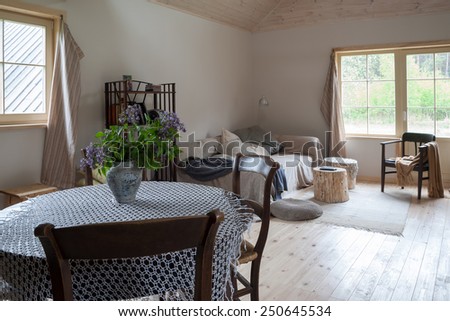 Country style interior of a living room with a round dining table
