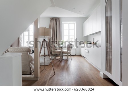 White attic apartment interior with shabby chic furniture