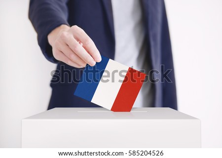 Man putting a ballot with French flag into a voting box.