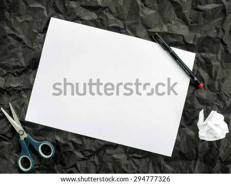 white paper on crumpled  black paper