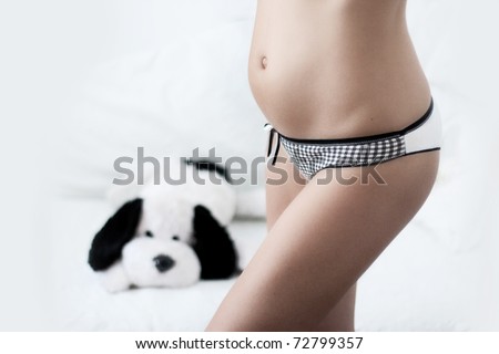 pregnant woman with soft toy in background