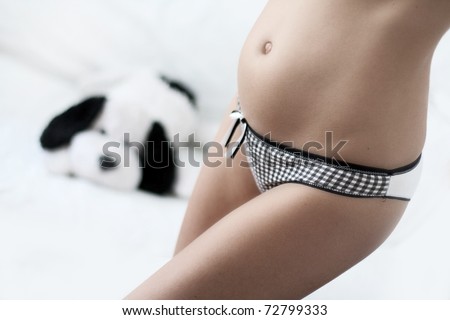 pregnant woman with soft toy in background