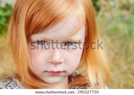 incredibly beautiful and sad red-haired girl with big piercing eyes