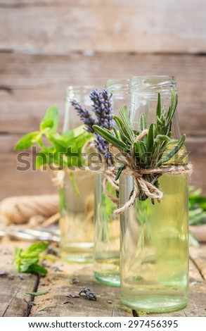 lavender water in glass bottles, decorated with herbs and flowers