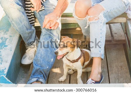 dog in a wooden boat on the background of couples in love