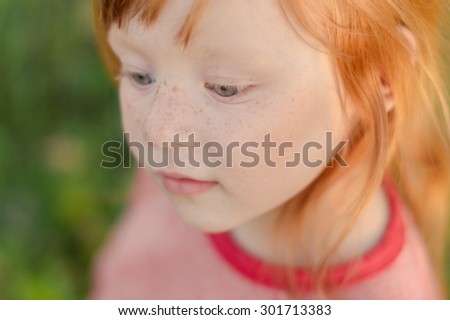 gentle red-haired little girl with freckles - toned portrait
