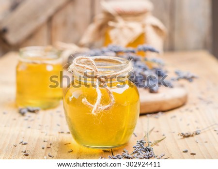 lavender honey in glass jars on wooden rustic table - Bohemian style