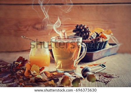 Tea with honey and spices, concept of autumn postcard, effect of a couple