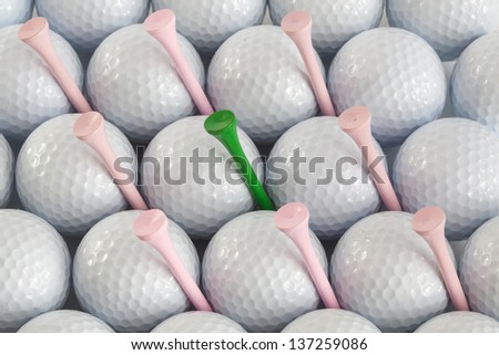 White golf balls and different tees