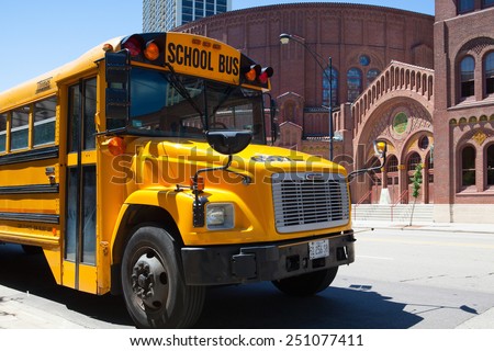 Chicago,USA - July 12,2013 : Typical american yellow school bus in front of the D.L.Moody memorial church and sunday school in Chicago