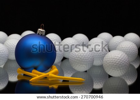 Blue Christmas decoration a golf balls on a black glass desk