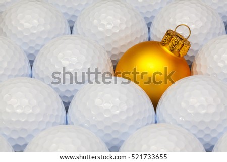 Gold  Christmas decoration between the white golf balls