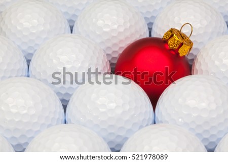 Red Christmas decoration between the white golf balls