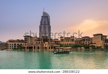 Dubai - June 5 : Wooden boat sails in lake of Dubai fountain show area near Dubai mall and Burj Khalifa on June 5, 2015 in Dubai.