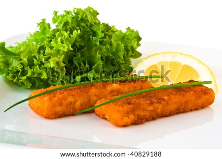 Fish stick with citron isolated on a white plate.