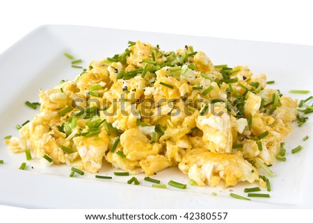 Scrambled eggs on white plate isolated