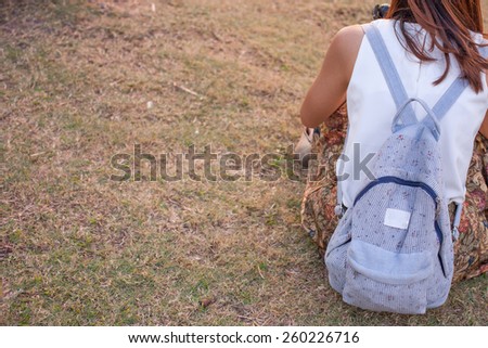 Back side of Lady with a backpack