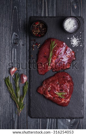Raw lamb meat on natural stone board.