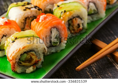 Sushi set: sushi roll with salmon and sushi roll with smoked eel, selective focus.