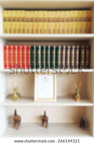 Blur Colorful Books  and Animal Figures on Wooden Book Shelf