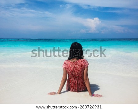 Back of Wet Asian Woman Sit on White Sand Beach and Looking at Crystal Clear Sea and Sky used as Template