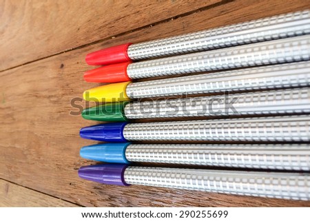 Colorful Marker Pens in Rainbow Order on Wooden Table used as Template