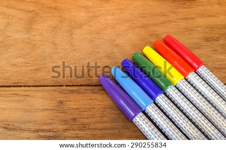 Colorful Marker Pens in Rainbow Order on Wooden Table used as Template