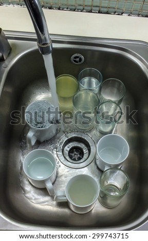 Ready to Wash Dirty Cups in The Stainless Sink