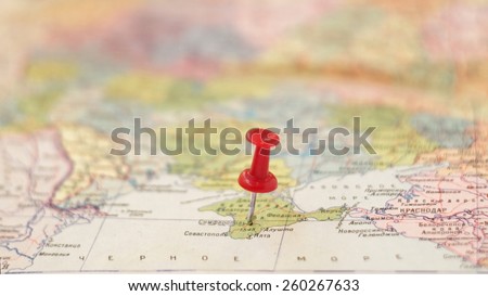 point on map concept: Simferopol pinned on the old Soviet map / partially out of focus, focus point on pushpin area