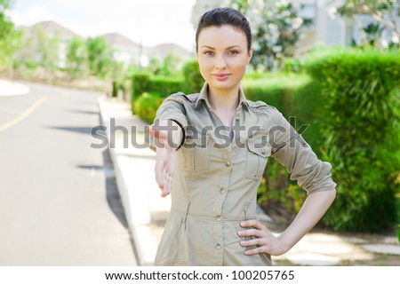 Pretty adult woman giving handshake near detached house. Real estate agent reaching agreement
