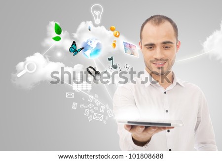 Poster portrait of handsome man holding his universal device - tablet pc. Lots of things are appearing from the display. Universality of modern devices concept
