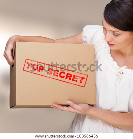 Portrait of young pretty woman with top secret package cardboard box with important information