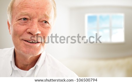 Old man is very happy with his new apartment in modern building. New apartment for old people concept