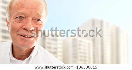 Old man is very happy with his new apartment in modern building. New apartment for old people concept
