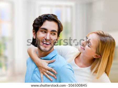Cozy young couple embracing inside new apartment and planning to buy it. Mortgage and new home concept