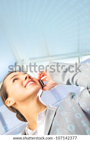 Portrait of beautiful business woman on the phone at modern building. Lots of copyspace