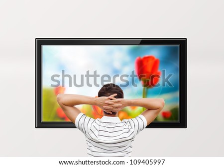 Adult man watching educational channel about nature by tv