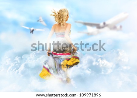 Young woman running through the clouds in the sky, birds and airplane flying at the background. Traveling or ticket booking concept