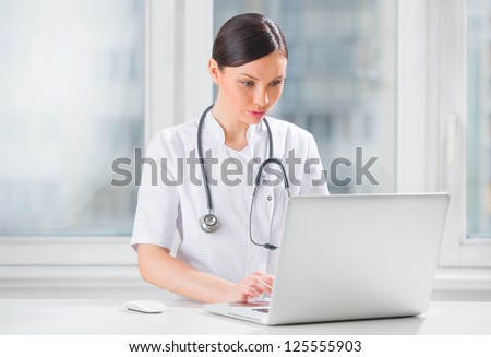 Portrait of a female doctor using her laptop computer at clinic