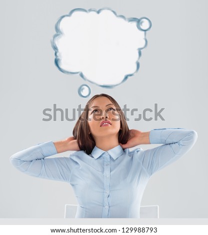 Image of young woman thinking of her plans. Lots of copyspace inside graphic cloud for your text