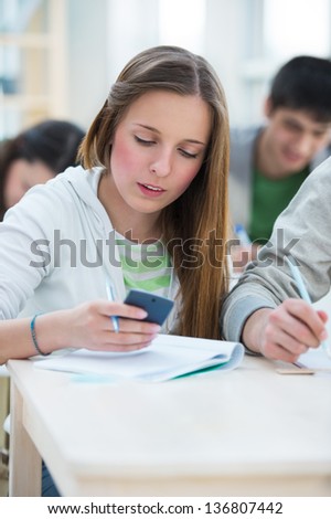 High School students. Beautiful girl calculating numbers in classroom during lesson