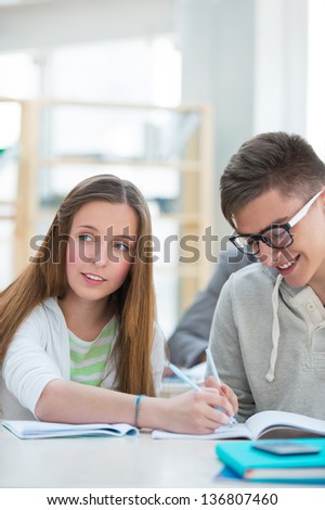 High School students. Girl and boy study together and help each other as they work