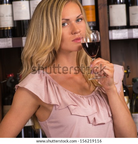 Woman in a supermarket degustating red wine