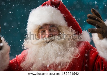 Happy Santa Claus laughing while standing outdoors at North Pole