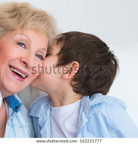 Grandmother With Grandson Having Fun At Home - Whispering Secrets