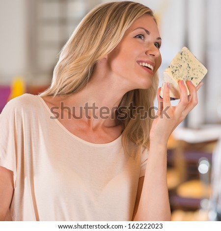 Woman buying cheese at grocery store